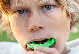 boy putting in mouthguard