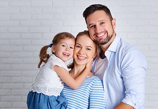 family of three smiling