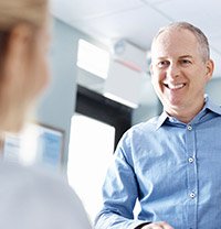 man smiling at front desk