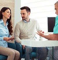 couple talking to dentist