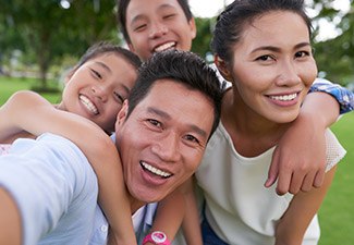 family of four smiling