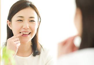 woman pointing to tooth