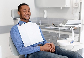 Man in blue shirt sitting in dental chair