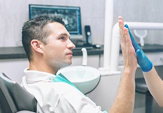 man giving dentist high five