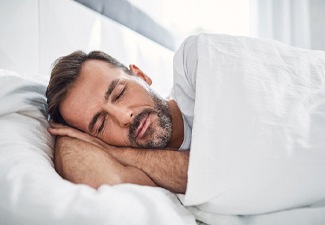 Man enjoying peaceful sleep with help of NightLase treatment
