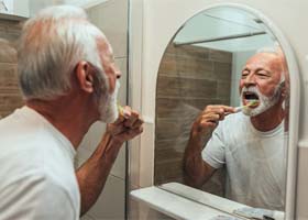 patient brushing dental implants