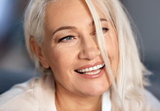 woman smiling after getting dental implants in Leawood