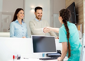 Dental employee shaking hands with a patient