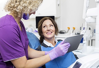 An older woman with dental implants in Leawood visiting dentist