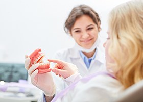 Implant dentist in Leawood teaching patient how dental implants work