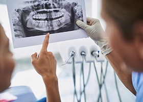 Implant dentist in Leawood showing patient an X-ray