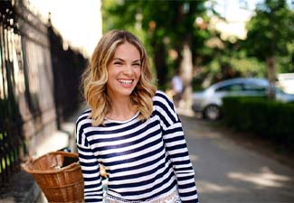 Woman with dental implants in Leawood smiling outside