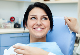 young woman smiling at dentist