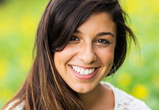 teen smiling outside