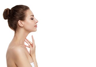 Side view of young woman with smooth neck