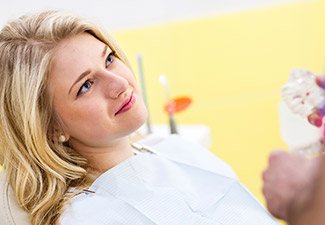 young woman listening to dentist