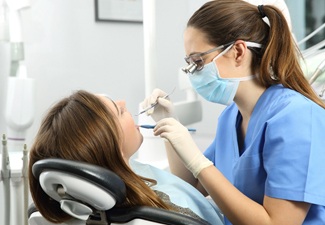 dental hygienist performing procedure