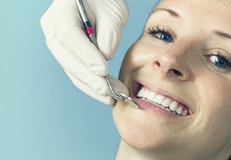 woman in dentist chair smiling