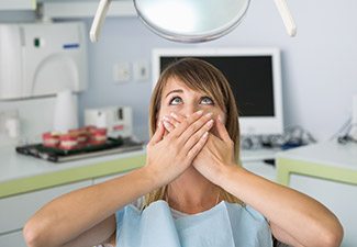 woman covering smile