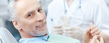 man smiling in exam chair