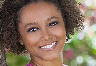 woman smiling by tree