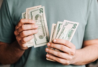 Close up of man’s hands counting cash