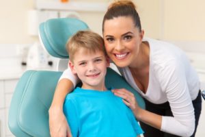 mother posing with son at dentist