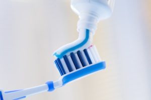 toothpaste going on toothbrush