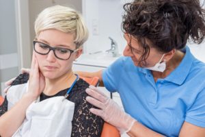 Woman asking dentist what constitutes a dental emergency.