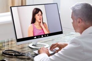 Dentist in Leawood videoconferencing with patient 