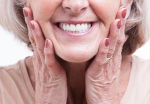 a woman happy about her complete smile with dentures