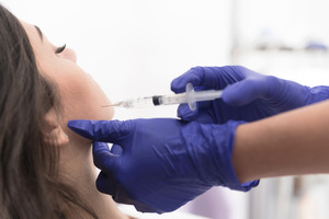 Female patient having BOTOX injected into jaw